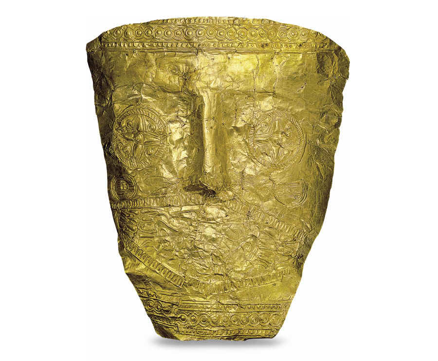 Χρυσή μάσκα, γύρω στο 540-530 π.Χ. Η διακόσμηση έχει διαμορφωθεί από τον τεχνίτη με τέσσερις μήτρες. Δυτικό Νεκροταφείο Αρχοντικού Πέλλας – Τάφος Τ 458. Αρχαιολογικό Μουσείο Πέλλας, Α.Κ. 2005/458, αρ. 60.